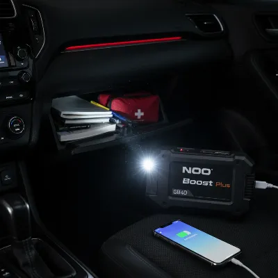 NOCO Boost Plus GB40 showing its flashlight and USB charging function in a car interior
